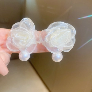 Detail view of lace organza flower earrings with glossy faux pearl pendants
