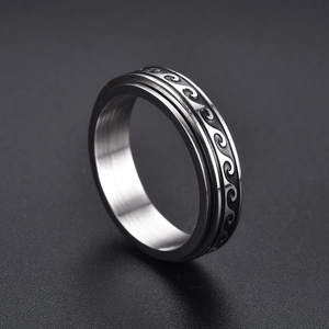 Rotating stainless steel stress relief ring with black wave pattern in silver finish