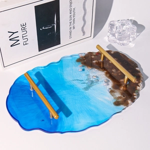 Detail of DIY ocean theme resin tray with gold handles and irregular wavy edges