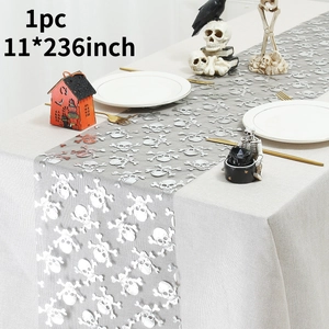 Macro detail of 11x236 inch grey Halloween table runner with white skull motifs