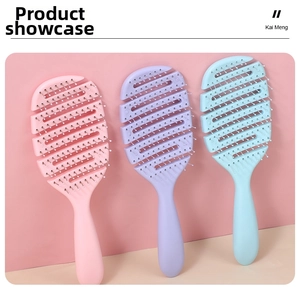 Close-up of three vented hair brushes in pink, purple, and blue for scalp massage