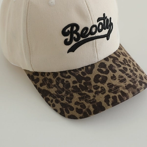 Kids leopard print baseball cap with Beooty embroidery on a beige canvas surface