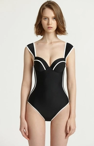 Detail view of the support cups and contrast white trim on the black one-piece swimsuit