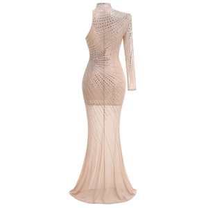 Close-up of sparkling rhinestones on nude mesh fabric of a one-shoulder fishtail dress