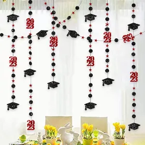 Close-up of 2023 graduation banner with glittery mortarboard and star hanging decorations