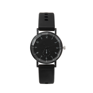 Minimalist quartz watch with black silicone strap and heart detail on dial clock hands