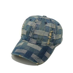 Macro view of woven denim baseball cap with distressed details and vintage texture