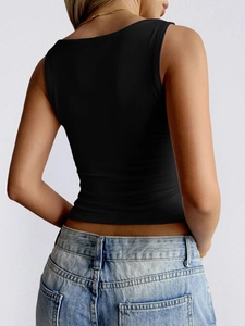 Rear view detail of a sleek black tight tank top paired with high waist vintage blue jeans