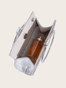 Interior view of silver glitter evening clutch bag holding a phone and perfume