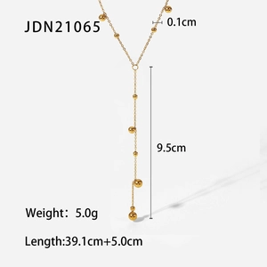 Detailed view of 18K gold plated Y-shaped necklace with long tassels and delicate beads
