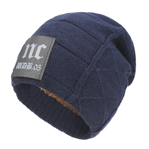 Winter thermal knit beanie in navy blue with thick brown fleece lining and leather patch