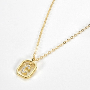 Detail of a gold S925 sterling silver necklace featuring a sparkling zircon letter C pendant