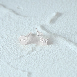 Macro shot of S925 sterling silver flat back earring with hanging clear gemstone detail