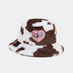 Detail of cute cat embroidery on pink heart patch over plush cow print bucket hat
