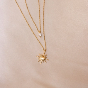 Elegant gold double-layer necklace with star pendant and zircon on silk background