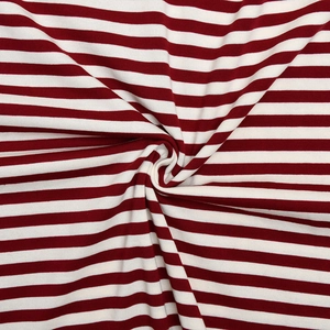 Macro shot of red and white striped knit fabric texture with soft artistic drape
