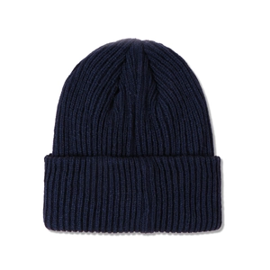 Detailed macro view showing the navy blue ribbed texture of this autumn knit beanie