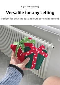 Detailed view of handmade felt Christmas gift box ornaments with hand-stitched edges