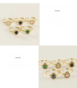 Detail of adjustable stainless steel rings with heart and teardrop colorful zircons