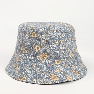 Close-up of blue cotton bucket hat with white floral print and fine stitching details