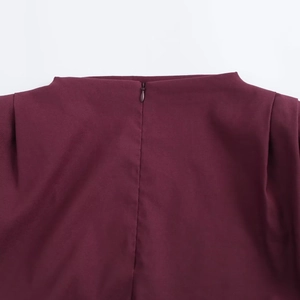 Detail of wine red sleeveless top showing hidden back zipper and woven texture