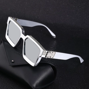 Detail of silver oversized square sunglasses with sparkling rhinestones and a black case