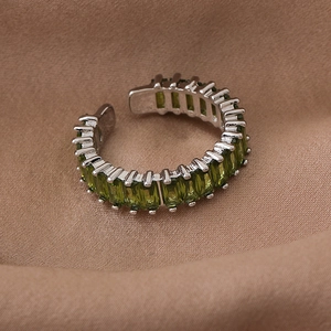Macro detail of adjustable silver ring with olive green square-cut zircon stones