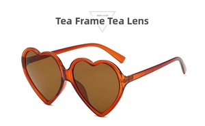 Detail of heart-shaped sunglasses featuring translucent tea frames and matching lenses
