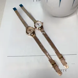 Close-up of rose gold women's quartz watches with mesh bands and Roman numeral dials