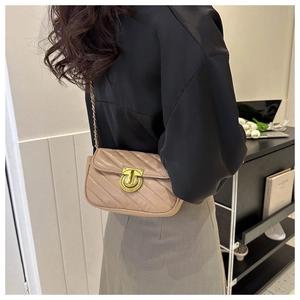 Chic beige V-quilted chain bag with gold rotary lock shown on model for size and fit