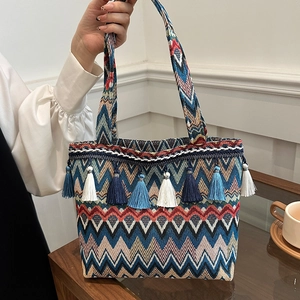 Ethnic style oversized woven tote bag with colorful chevron pattern and fringe trim