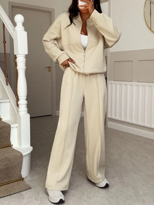Detail view of a beige two-piece lounge set with a zip-up cardigan and wide-leg pants