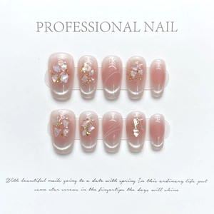 Cat eye press-on nails with shell fragments, gold foil and pearls on nude pink gradient