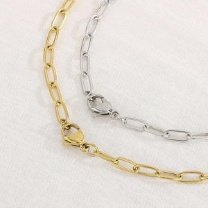 Detailed close-up of gold and silver paperclip link necklaces with lobster clasps