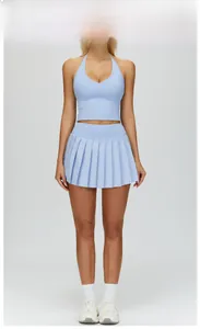 Front view of light blue athletic set with V-neck halter top and pleated mini skirt