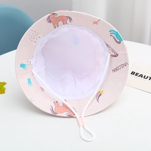 Detail of pink kids bucket hat with unicorn print, white lining, and adjustable chin strap