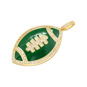 Detail of gold football pendant with green enamel and sparkling zircon stone inlay