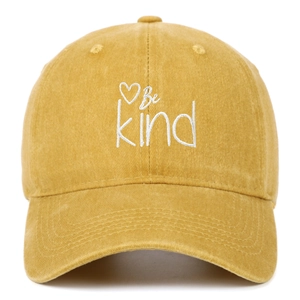 Close-up of Be Kind embroidery and heart on yellow washed canvas baseball cap