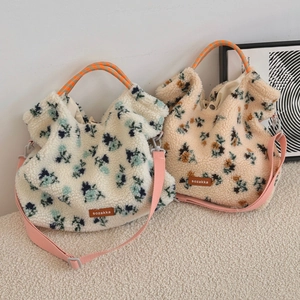 Detail of floral lamb wool tote bags with plush texture, leather patch and crossbody straps