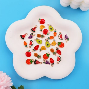 Colorful fruit alloy charms for DIY jewelry making displayed in a white floral tray
