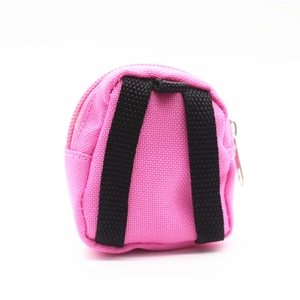 Close-up of a mini pink canvas backpack coin purse with black straps and metal zipper