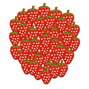 Pile of embroidered red strawberry patches with white dots and green leaves for clothing