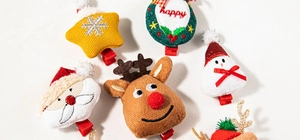 Close-up of plush Christmas hair clips featuring reindeer, Santa, and snowman designs