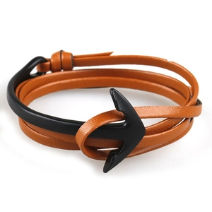 Macro view of brown multilayer leather cord with black metal anchor hook fastener