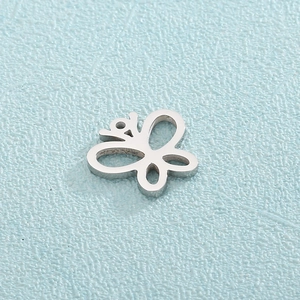Detailed close-up of a hollow silver butterfly pendant charm in polished stainless steel