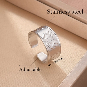 Macro shot of 1.3cm wide matte stainless steel adjustable ring with Evil Eye relief