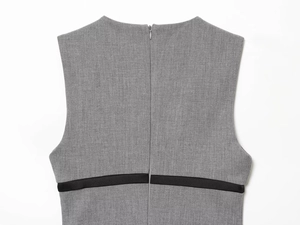 Detail of gray sleeveless dress back showing invisible zipper and black waist strap