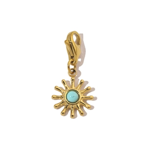 Detailed view of a gold sun pendant with turquoise stone and lobster clasp closure