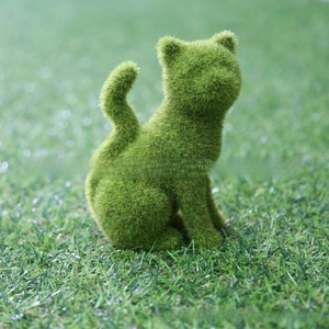Macro detail showing the realistic green flocking texture on a sitting cat garden ornament