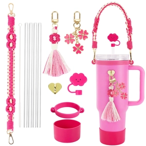 Pink daisy cup accessory set with woven strap, tassels, straw cover and silicone boot